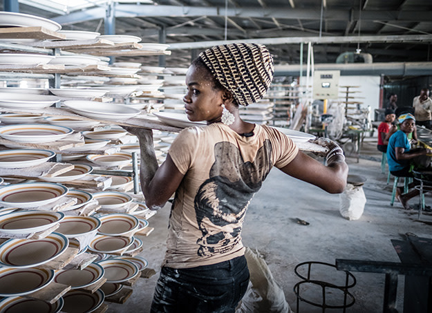 A worker arranges a rack of ceramics. Guangdong Free Trade Zone Igbesa, Ogun state Nigeria.