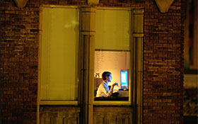 Lone office worker working into the night