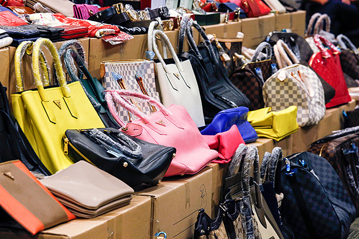 Counterfeit handbags are displayed by Customs and Excise Department during a news conference in Hong Kong September 19, 2014. The customs and the police in the territory have conducted a joint operation to combat the selling of counterfeit products at two storehouses, seizing 2,360 counterfeit goods valued at over HK$1 million (approx. $128,000). Two men were arrested in the operation, according to the official press release from the customs. REUTERS/Bobby Yip (CHINA - Tags: CRIME LAW BUSINESS) - GM1EA9J1CGL01