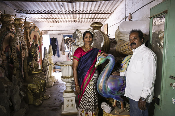 Indira and Sunder Raj pose for a photograph in their idol making workshop in Bangalore, India. Indira supports her family business regularly borrowing from Ujjivan to procure raw material.