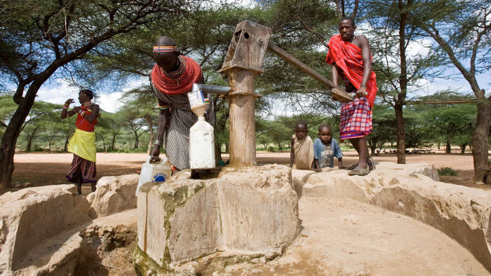 NAIROBI, KENYA - JUNE 30: A Samburu family pump a well for fresh water nera their home in a village in the Samburu National Reserve, on December 06, 2007 in Samburu, Kenya
