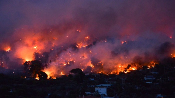 TOPSHOT - Flames rise as a wildfire burns in the town of Rafina, near Athens, on July 23, 2018.  / AFP PHOTO / ANGELOS TZORTZINISANGELOS TZORTZINIS/AFP/Getty Images