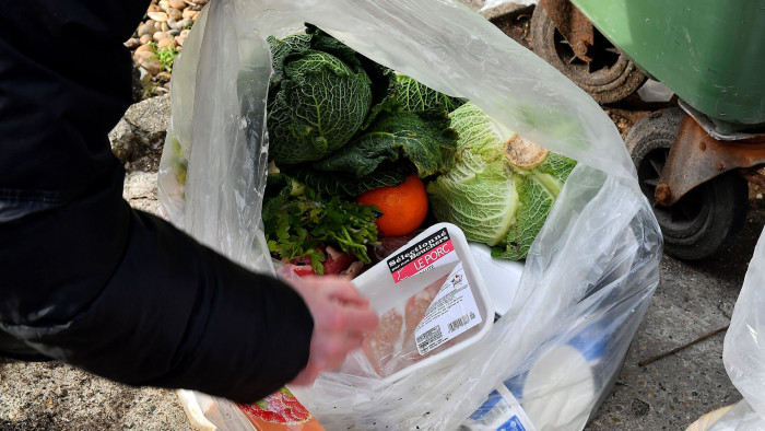 A French bailiff records the waste of food in the dustbin of Leclerc supermaket in Mimizan-Plage, southwestern France on February 4, 2019 as a claim is to be filed. (Photo by GEORGES GOBET / AFP) (Photo credit should read GEORGES GOBET/AFP via Getty Images)