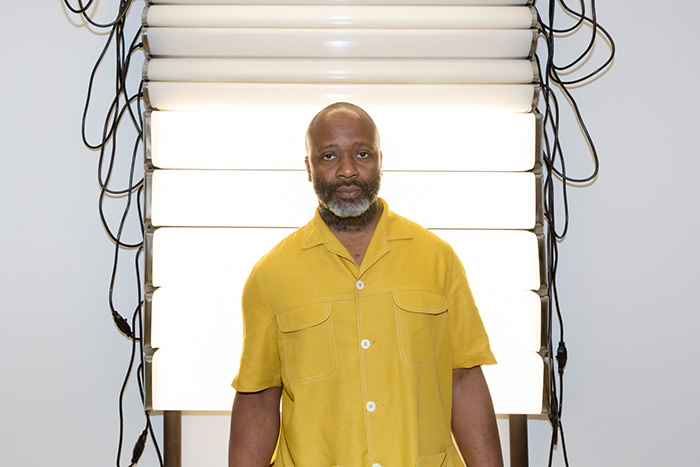 Theaster Gates in front of his work 'Bathroom Believer' (2018)