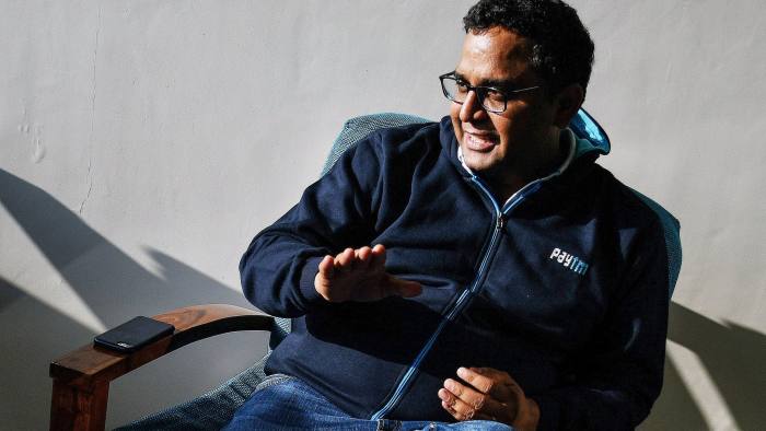 Vijay Shekhar Sharma, founder and chairman of One97 Communications Ltd., operator of PayTM, left, talks during a meeting at the company's office in Noida, Uttar Pradesh, India, on Wednesday, Dec. 14, 2016. India's largest digital payments company says it has signed up more than 20 million users for a total of 177 million since the government two months ago, with no warning, said it was scrapping 500- and 1,000-rupee banknotes, in a stroke excising four-fifths of the nation's paper money. Photographer: Anindito Mukherjee/Bloomberg