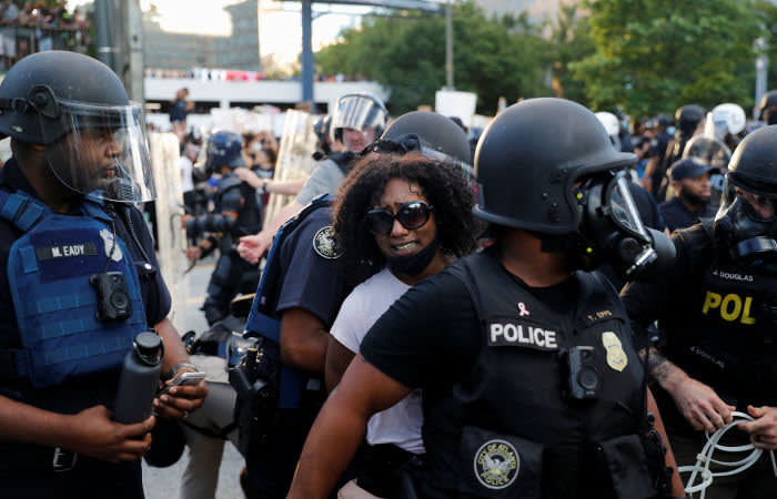 A protester is detained by police officers during a protest against the death in Minneapolis police custody of George Floyd, in Atlanta, U.S., May 30, 2020. REUTERS/Shannon Stapleton - RC2CZG9YAWQP