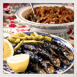 Sardines wrapped in vine leaves then barbecued
