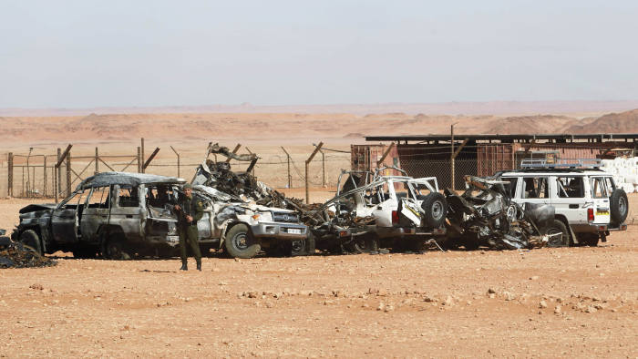 An Algerian soldier stands near damaged cars used by Islamist militants during a siege earlier this month near the Tiguentourine Gas Plant in In Amenas, 1600 km (994 miles) southeast of Algiers, January 31, 2013. REUTERS/Louafi Larbi (ALGERIA - Tags: MILITARY POLITICS CRIME LAW) - GM1E92106MP02