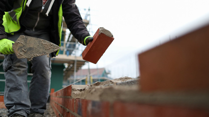A builder lays bricks at a Persimmon Plc residential property construction site in Weston-Super-Mare, U.K., on Thursday, Jan. 26, 2017. Persimmon -- the U.K.'s largest homebuilder by market value -- designs, develops and builds residential housing units ranging from studio apartments to executive family homes throughout the United Kingdom. Photographer: Chris Ratcliffe/Bloomberg