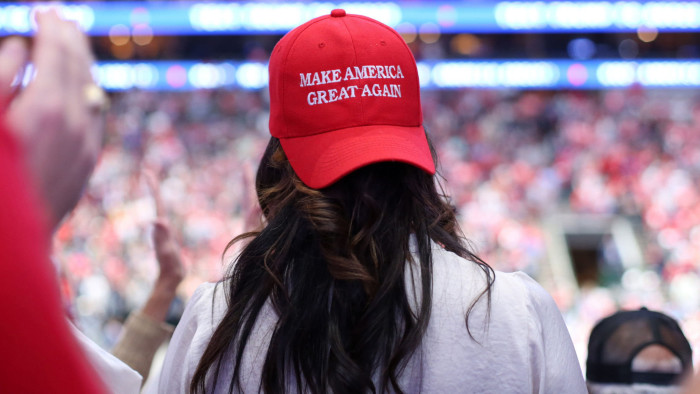 An attendee wears a red campaign hat that reads &quot;Maek America Great Again&quot; during a rally with U.S. President Donald Trump, not pictured, in Dallas, Texas, U.S., on Thursday, Oct. 17, 2019. Trump's Doral golf resort in Miami will be the site of next year's Group of Seven summit, a decision that reignited claims he's violating a constitutional prohibition against profiting from the presidency. Photographer: Dylan Hollingsworth/Bloomberg