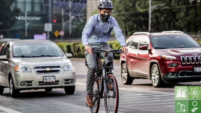 A man rides a bicycle next to traffic along the Paseo de la Reforma in Mexico City, Mexico, on Wednesday, Aug. 10, 2016. Mexico's push to reduce air pollution may set the stage for a surge in clean energy-related bond sales. For the first time, the government will auction $8 billion worth of clean energy projects this year, according to Pricewaterhouse Cooper. Photographer: Brett Gundlock/Bloomberg