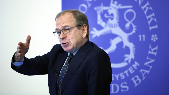 Erkki Liikanen, governor of the Bank of Finland, gestures whilst speaking during a news conference in Helsinki, Finland, on Monday, March 21, 2016. &quot;Taking into account the current inflation outlook, our policy rates are expected to remain at present or lower levels for an extended period of time, and well past the horizon of the asset purchases,&quot; Liikanen said in a press release. Photographer: Ville Mannikko/Bloomberg