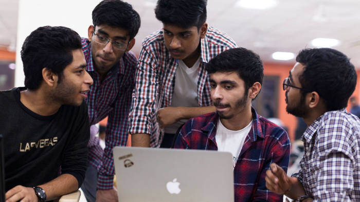 In this picture taken on October 27, 2018, Indian undergraduate students discuss their project as they take part in HackCBS, a 24 hour event of software development also called 'hackathon', at the Shaheed Sukhdev College of Business Studies (SSCBS) in New Delhi. - Students from all over India gathered in teams to take part in a challenge to develop their ideas in the fields of Internet of Things (IoT), Artificial Intelligence (AI), Blockchain, Mobility and Education and Financial technology. (Photo by XAVIER GALIANA / AFP) (Photo credit should read XAVIER GALIANA/AFP via Getty Images)