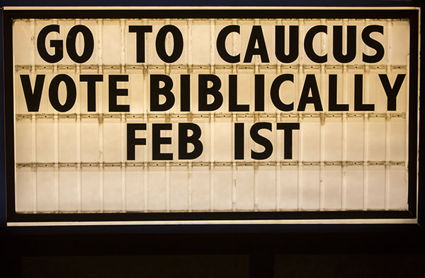 A marquee with the phrase &quot;Go To Caucus Vote Biblically&quot; is seen outside the Fort Des Moines Church of Christ during a Wednesday night service in Des Moines, Iowa, U.S., on Wednesday, Jan. 27, 2016. Monday's first-in-the-nation caucuses will cap months of presidential candidates crisscrossing the plains and prairie, wooing voters of all stripes and evangelical Christians in particular. Photographer: Patrick T. Fallon/Bloomberg