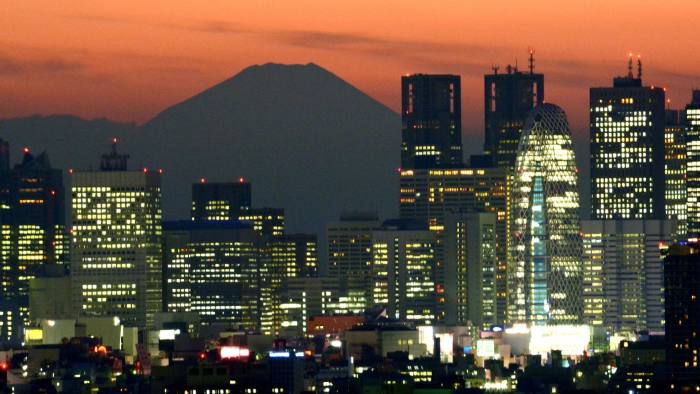 Japan's highest mountain Mount Fuji (top C) is seen behind the skyline of the Shinjuku area of Tokyo at sunset on November 27, 2014. Tokyo stocks lost 0.78 percent on November 27 as a stronger yen took the wind out of the market ahead of the US Thanksgiving holiday. AFP PHOTO / KAZUHIRO NOGIKAZUHIRO NOGI/AFP/Getty Images