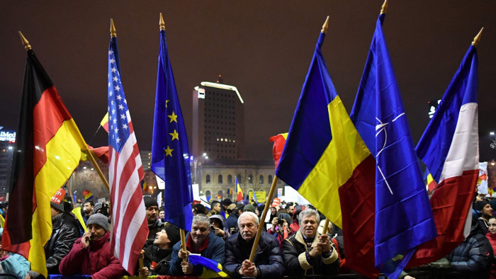 TOPSHOT - People protest in front of the government headquarters in Bucharest, against the government's contentious corruption decree February 4, 2017. Romania's prime minister said the government would repeal a contentious corruption decree that has sparked the biggest protests since the fall of dictator Nicolae Ceausescu in 1989. / AFP PHOTO / DANIEL MIHAILESCUDANIEL MIHAILESCU/AFP/Getty Images