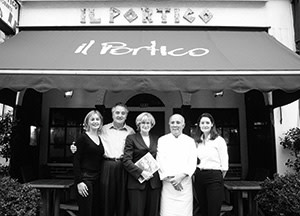 The proprietors of Il Portico pose in front of their family restaurant on Kensington High Street