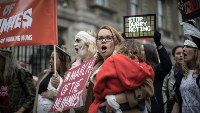 Protesters march along Whitehall to protest about the employment law surrounding women and pregnancy.