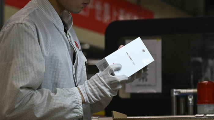 An employee works on a mobile phone production line at a Huawei production base during a media tour in Dongguan, China's Guangdong province on March 6, 2019. - Chinese telecom giant Huawei gave foreign media a peek into its state-of-the-art facilities on March 6 as the normally secretive company steps up a counter-offensive against US warnings that it could be used by Beijing for espionage and sabotage. (Photo by WANG ZHAO / AFP) (Photo credit should read WANG ZHAO/AFP via Getty Images)