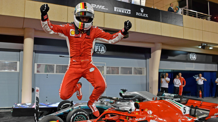 TOPSHOT - Ferrari's German driver Sebastian Vettel jumps out of his car after winning the Bahrain Formula One Grand Prix at the Sakhir circuit in Manama on April 8, 2018. / AFP PHOTO / Andrej ISAKOVIC (Photo credit should read ANDREJ ISAKOVIC/AFP/Getty Images)