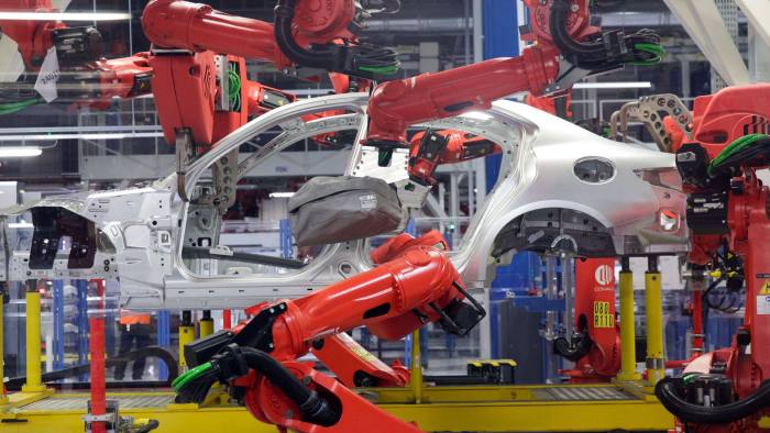 Robotics arms, manufactured by Comau SpA, work on an Alfa Romeo Giulia automobile on the production line at Fiat Chrysler Automobiles NV's Alfa Romeo assembly plant in Cassino, Italy, on Thursday, Nov. 24, 2016. President-elect Donald Trump's critical stance toward free trade could affect Fiat Chrysler Automobiles NV's business in North America, according to the Italian automaker's chief executive officer Sergio Marchionne. Photographer: Matthew Lloyd/Bloomberg