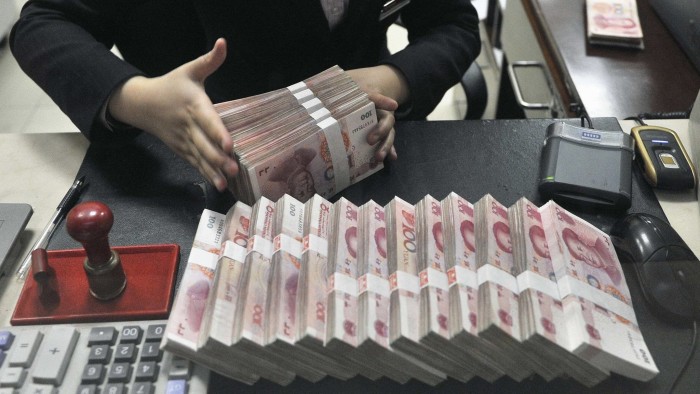 A clerk arranges bundles of 100 Chinese yuan banknotes at a branch of China Merchants Bank in Hefei...A clerk arranges bundles of 100 Chinese yuan banknotes at a branch of China Merchants Bank in Hefei, Anhui province March 17, 2014. China's yuan eased against the dollar on Monday after the central bank doubled the currency's daily trading band as part of its commitment to let markets play a greater role in the economy. REUTERS/Stringer (CHINA - Tags: BUSINESS POLITICS)