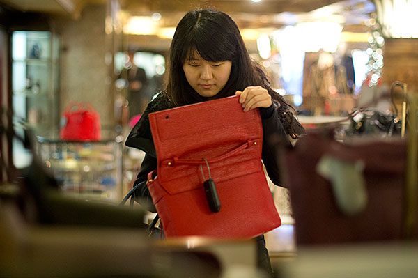 Chinese customer browsing the bag selection at Harrods