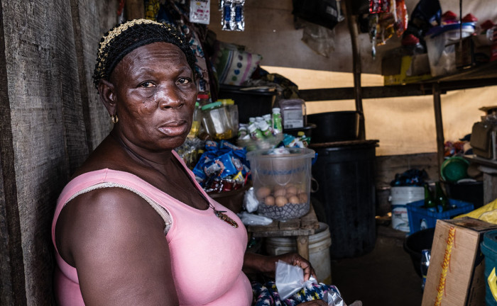 In community of Isale Ijebu in Ajah, Lagos; Mary Kunnu, Tinu's mother who lives with her daughter after being forcibly removed from their ancestral home in Otodo Gbame, sits down in her shop