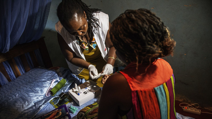 A medic with Doctors Without Borders (MSF) tests for HIV a sex worker in her room along the Beira &quot;corridor&quot; on October 17, 2014 in Beira, Mozambique. The Beira corridor is a strip of land running from the Indian Ocean port of Beira, Mozambique's second city, to Zimbabwe's eastern border. The World Health Organization (WHO) says there were some 35 million people around the world living with HIV by the end of 2013, with some 2.1 million new infections during the course of that year. Sub-Saharan Africa is the most affected region, with almost 70 percent of new infections. AFP PHOTO/GIANLUIGI GUERCIA (Photo credit should read GIANLUIGI GUERCIA/AFP via Getty Images)