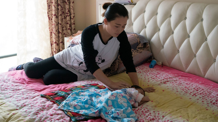 Safely delivered: Wan Xindi back at her home in Yichang with her newborn daughter Xiaozuo