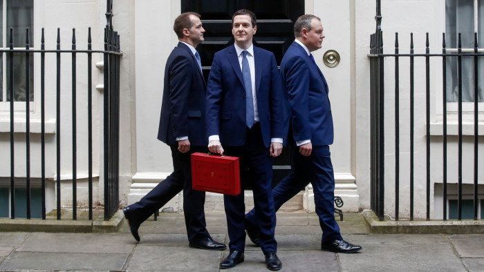 George Osborne, U.K. chancellor of the exchequer, centre, holds the dispatch box containing the budget, as members of the H.M. Treasury team walk past the door of 11 Downing Street in London, U.K., on Wednesday, March 16, 2016. Osborne is set to unveil sweeping education reforms in his Budget on Wednesday as he seeks to sweeten the pill of austerity three months before the referendum on European Union membership. Photographer: Simon Dawson/Bloomberg *** Local Caption *** George Osborne
