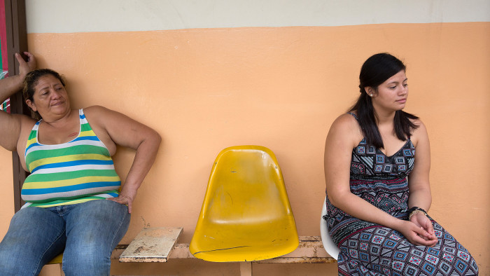 Maria (right) and her mother at the San Salvador school where Maria helps with Sunday service