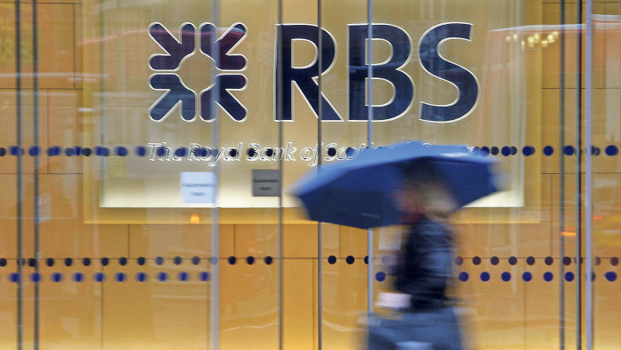 File photo dated 03/12/09 of a woman walking past the headquarters of the Royal Bank of Scotland in the City of London