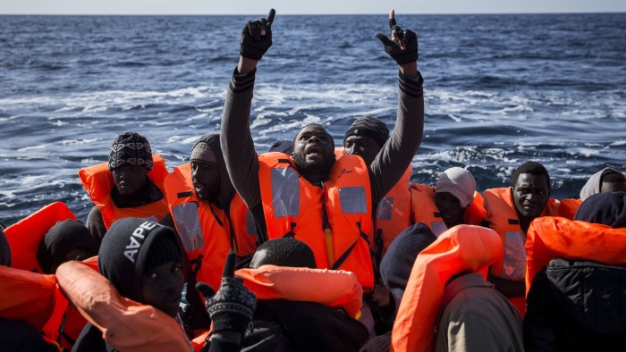 Sub-Saharan migrants react inside a dinghy as they are rescued by members of Proactiva Open Arms NGO at the Mediterranean sea, about 20 miles north of Ra's Tajura, Libya, Thursday, Jan. 12, 2017. About 300 migrants were rescued Tuesday from three dinghies by members of Proactiva Open Arms Spanish NGO and Italian coast guards before transferring them to the Italian coast. (AP Photo/Olmo Calvo)