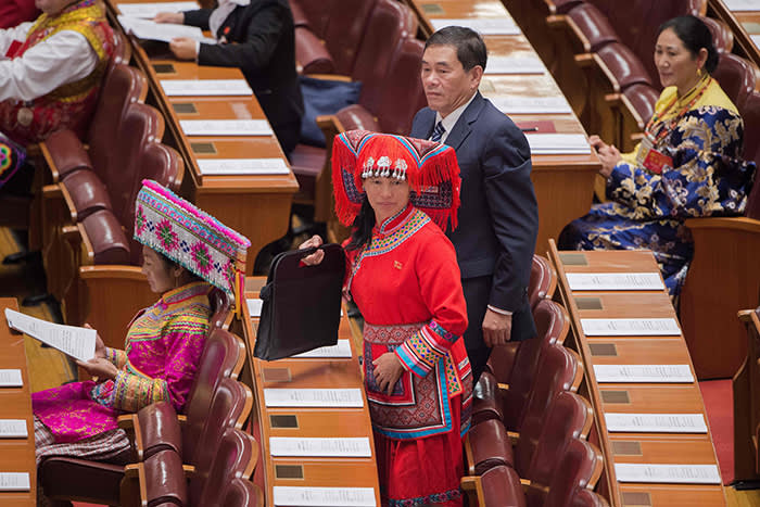 Delegates, some wearing ethnic minority outfits, arrive at the opening of the 19th Communist Party Congress at the Great Hall of the People in Beijing on October 18, 2017. President Xi Jinping declared China is entering a "new era" of challenges and opportunities on October 18 as he opened a Communist Party congress expected to enhance his already formidable power. / AFP PHOTO / NICOLAS ASFOURINICOLAS ASFOURI/AFP/Getty Images