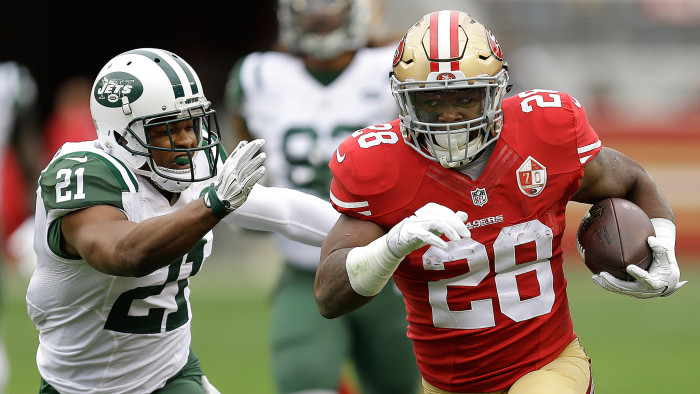 San Francisco 49ers running back Carlos Hyde (28) runs against New York Jets free safety Marcus Gilchrist (21) during the first half of an NFL football game in Santa Clara, Calif., Sunday, Dec. 11, 2016. (AP Photo/Ben Margot)