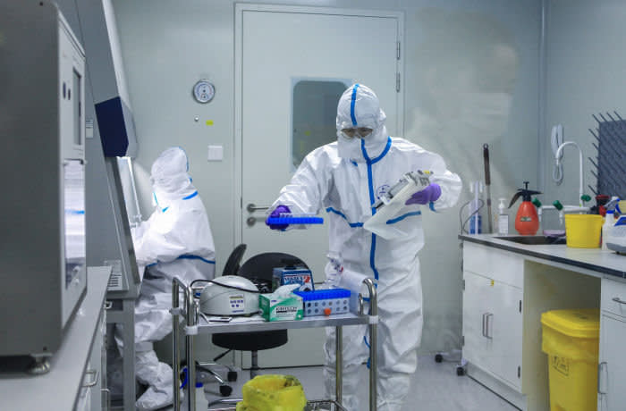 This photo taken on March 17, 2020 shows laboratory technicians working on testing samples from people to be tested for the COVID-19 coronavirus at a laboratory in Changzhou in China's eastern Jiangsu province. - China on March 19 marked a major milestone in its battle against the coronavirus pandemic as it recorded zero domestic infections for the first time since the outbreak emerged, but a spike in imported cases threatened its progress. (Photo by STR / AFP) / China OUT (Photo by STR/AFP via Getty Images)