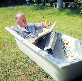 Piero Fornasetti in his Farfalle bathtub outdoors