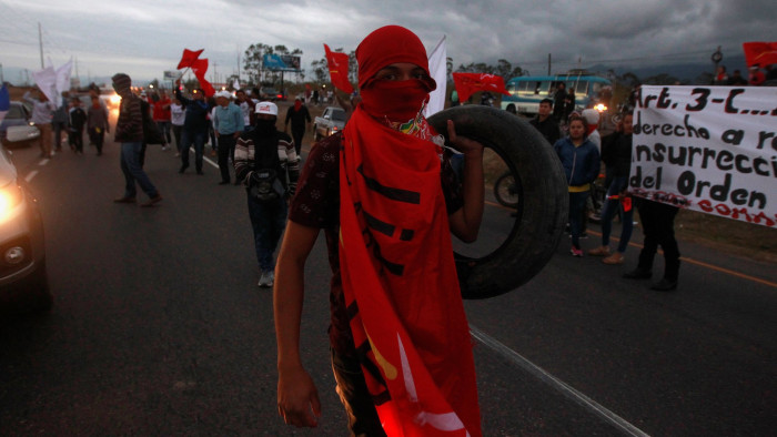 An opposition supporter carries a tire holds a during a protest against the re-election of Honduras' President Juan Orlando Hernandez, outside the Soto Cano Air Base in Comayagua, Honduras January 14, 2018. REUTERS/Jorge Cabrera - RC185D319610