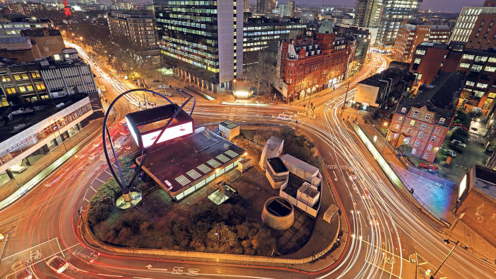 Light trails from traffic are seen as they pass around the Old Street roundabout, in the area known as London's Tech City, in London, U.K., on Tuesday, Dec. 17, 2013