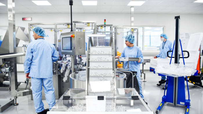 Operators work on the pre-filled syringes assembly line at AstraZeneca Plc's new Biologics factory in Sodertalje, Sweden, on Thursday, April 11, 2019. AstraZeneca raised its annual sales forecast, helped by demand for the U.K. drugmaker's roster of new cancer drugs. Photographer: Mikael Sjoberg/Bloomberg via Getty Images