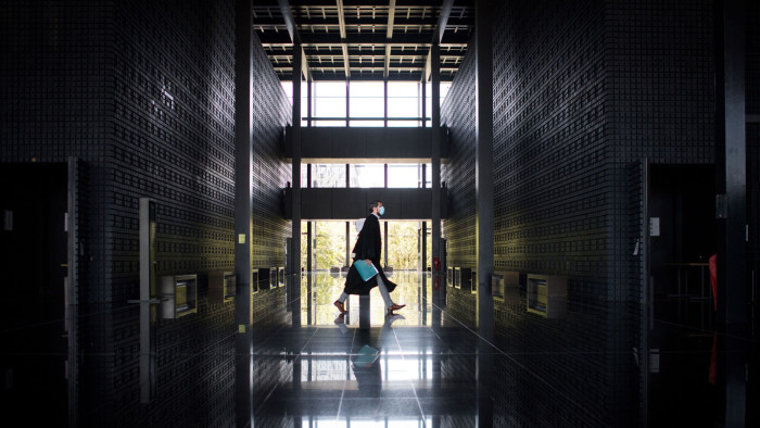 TOPSHOT - A lawyer wearing a face mask walks down a corridor  on May 26, 2020 at the courthouse in Nantes, western France, amid the crisis caused by the Covid-19 pandemic (novel coronavirus). (Photo by Loic VENANCE / AFP) (Photo by LOIC VENANCE/AFP via Getty Images)