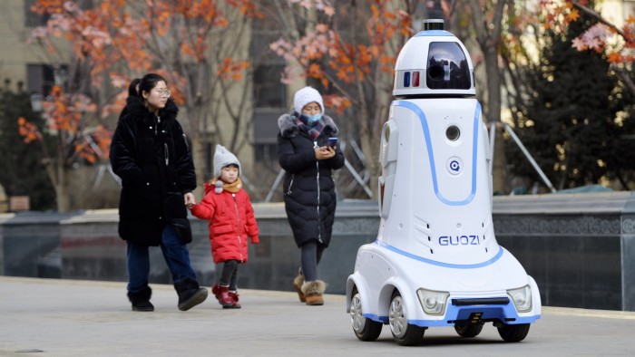 HOHHOT, CHINA - JANUARY 18: A security robot goes on patrol at a community on January 18, 2019 in Hohhot, Inner Mongolia Autonomous Region of China. The security robots, equipped with panoramic camera and far infrared system, are able to communicate with people, recognize strangers and automatically alarm when noticing something abnormal. (Photo by Wang Zheng/VCG via Getty Images)