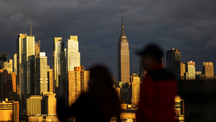 People take a look at the New York City skyline of Manhattan and the Hudson River during the outbreak of the coronavirus disease (COVID-19) in New York City, as seen from Weehawken, New Jersey, U.S. April 18, 2020. REUTERS/Eduardo Munoz