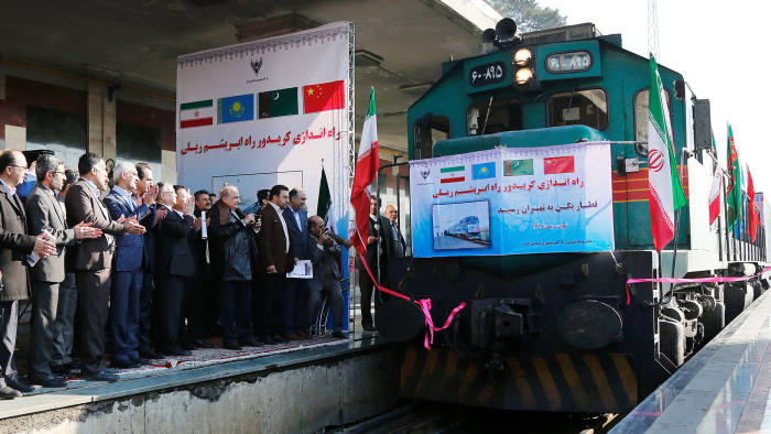 Iranian officials applaud on the platform as the first train connecting China and Iran arrives at Tehran Railway Station on February 15, 2016