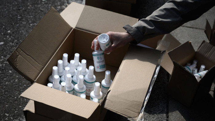 A volunteer of Medecins Sans Frontieres (MSF Doctors Without Borders) medical charity organisation prepares to distribute bottles of hand sanitizer to the needy in Geneva on May 16, 2020, as the COVID-19 pandemic casts a spotlight on the usually invisible poor people of Geneva, one of the world's most expensive cities. (Photo by Fabrice COFFRINI / AFP) (Photo by FABRICE COFFRINI/AFP via Getty Images)