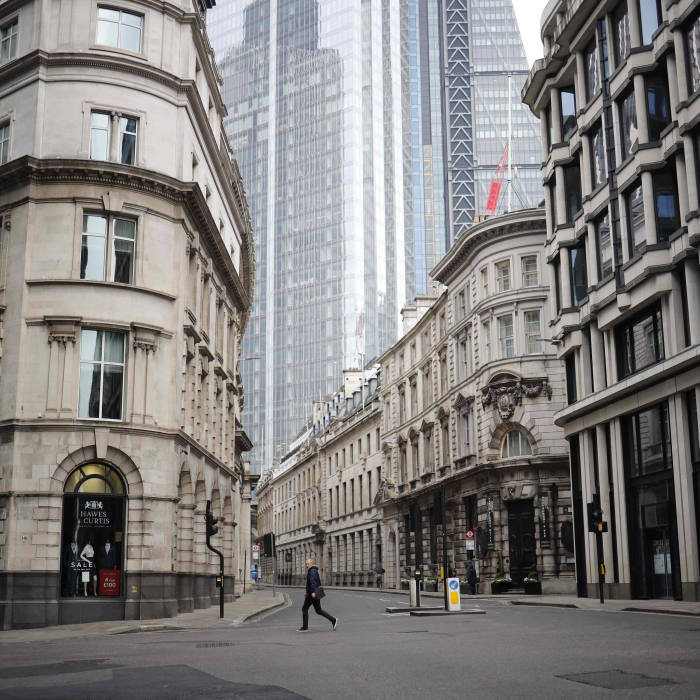 A pedestrian walks the near-deserted streets of the City of london on April 16, 2020, during the novel coronavirus Covid-19 pandemic. - The British government on Thursday was expected to extend a nationwide lockdown for another three weeks, while the country's coronavirus death toll spiked by 861 -- a greater increase than in recent days. (Photo by Tolga Akmen / AFP) (Photo by TOLGA AKMEN/AFP via Getty Images)