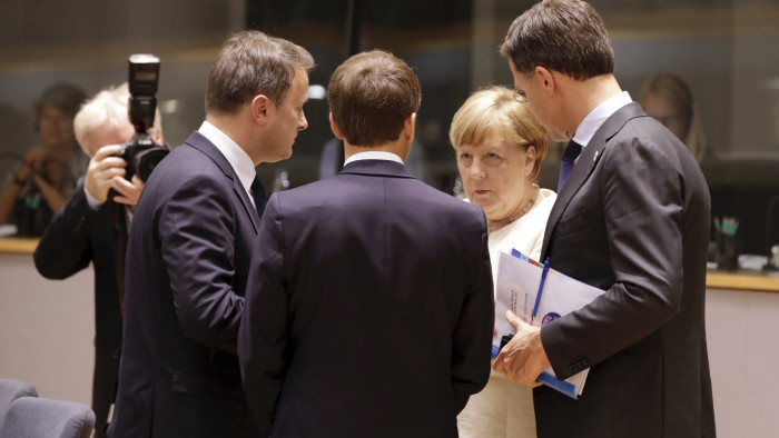 German Chancellor Angela Merkel, second right, speaks with from left, Luxembourg's Prime Minister Xavier Bettel, French President Emmanuel Macron and Dutch Prime Minister Mark Rutte during a round table meeting at an EU summit in Brussels, Thursday, June 20, 2019. European Union leaders meet for a two-day summit to begin the process of finalizing candidates for the bloc's top jobs. (AP Photo/Olivier Matthys)