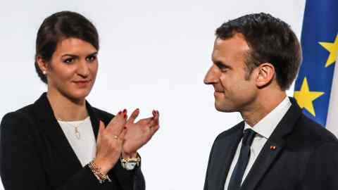 (From L) French humorist and patron of the association "Women Safe" Florence Foresti and French Junior Minister for Gender Equality Marlene Schiappa applaud after French President Emmanuel Macron (R) delivered a speech during the International Day for the Elimination of Violence Against Women, on November 25, 2017 at the Elysee Palace in Paris. / AFP PHOTO / POOL / LUDOVIC MARIN (Photo credit should read LUDOVIC MARIN/AFP/Getty Images)