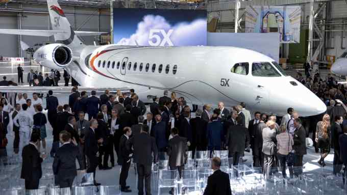 People stand next to Dassault Aviation's new business jet, the Falcon 5X, at the aircraft's assembly line during its presentation in Merignac on June 2, 2015. AFP PHOTO / JEAN-PIERRE MULLER (Photo credit should read JEAN-PIERRE MULLER/AFP/Getty Images)